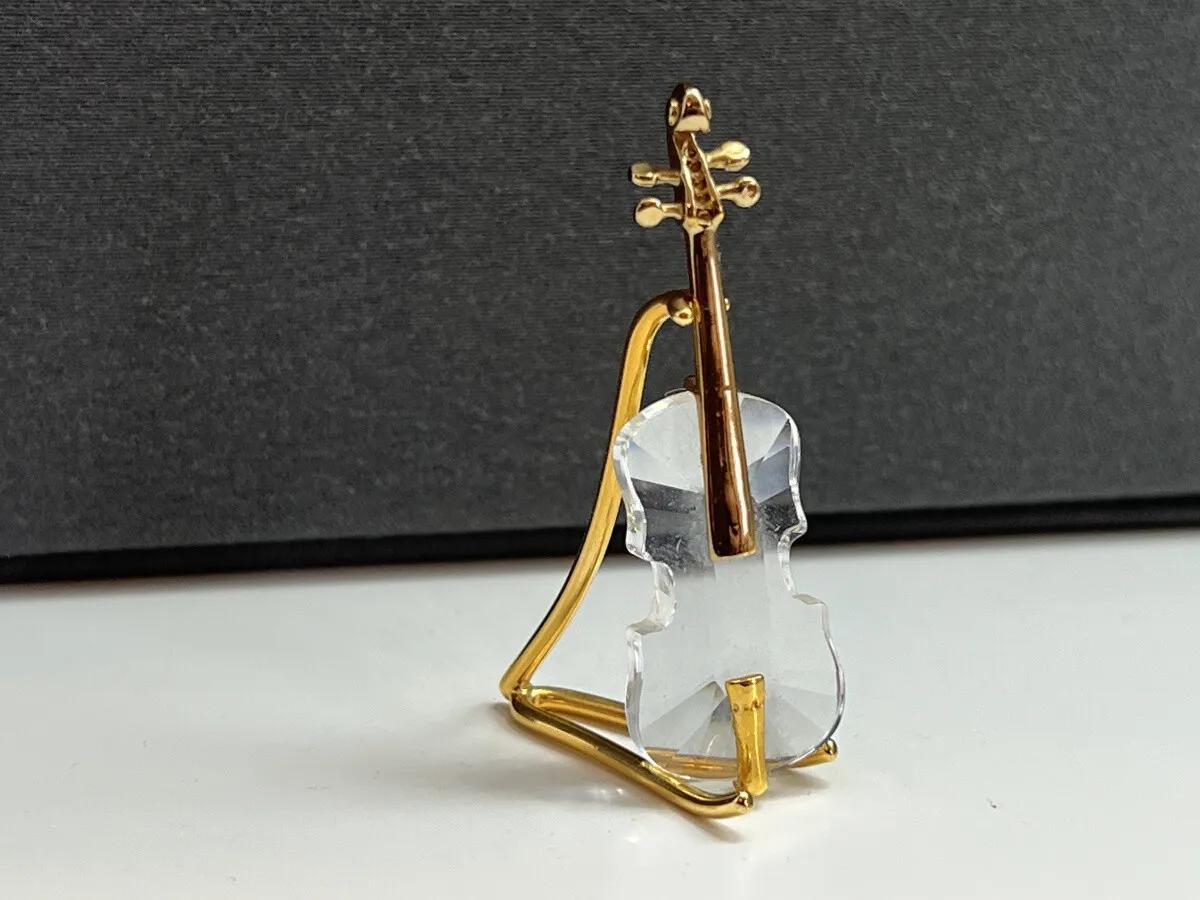 swarovski crystal violin - What is the difference between crystal and Swarovski crystal